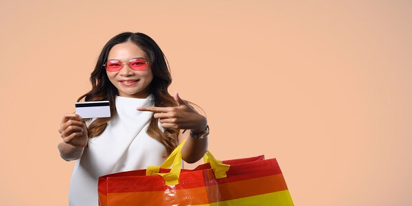 Smiling shopper holding a card and bags, highlighting smart loyalty program practices and common mistakes brands should avoid