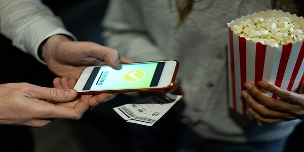 Customer redeeming movie reward from loyalty program at cinema