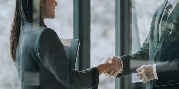 Business partners shaking hands, symbolizing growth and collaboration through the Novus Loyalty Partner Program.