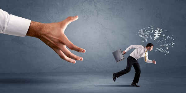 Illustration of a businessman running from a giant hand, symbolizing why retention marketing is essential for business growth.