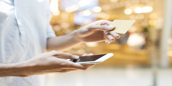 Shopper checking loyalty rewards on mobile card