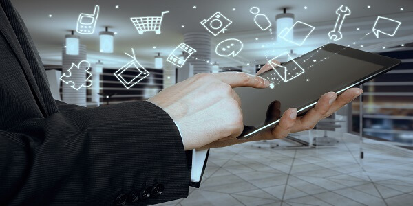 Businessman using tablet with omnichannel retail icons above