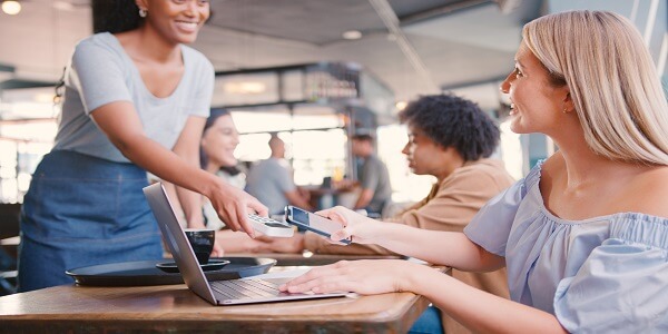 Customer using mobile payment and loyalty rewards in café
