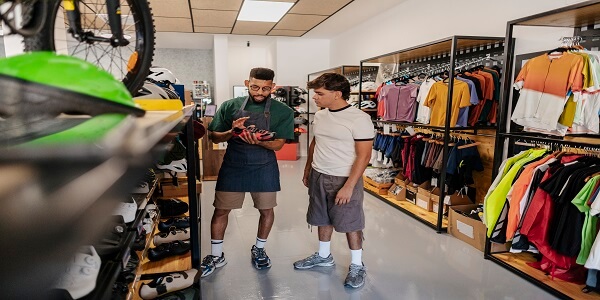 Retail staff helping customer in connected loyalty program store
