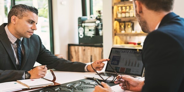 Two business owners discussing growth strategies, highlighting why loyalty programs are essential for small businesses.