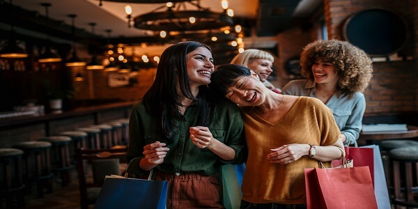 Group of happy shoppers enjoying their experience, reflecting customer satisfaction that helps build strong brand loyalty.