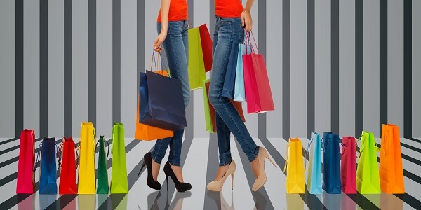 Shoppers with colorful bags symbolizing retail design that builds customer loyalty.