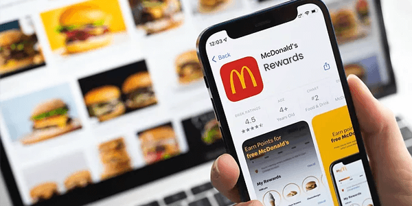 One man hand hold mobile & screen showing McDonalds Rewards Program
