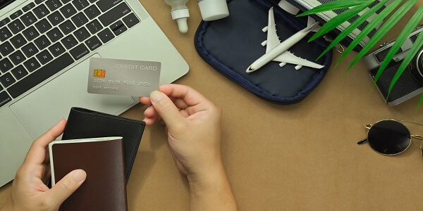 Credit card and passport representing modern travel rewards programs.