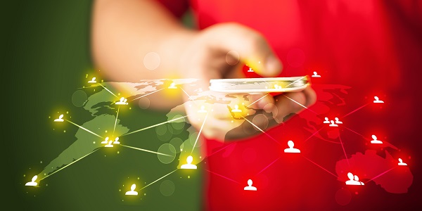 A person using a smartphone with a glowing global network of connected users, symbolizing digital connections and omnichannel customer engagement in loyalty programs.