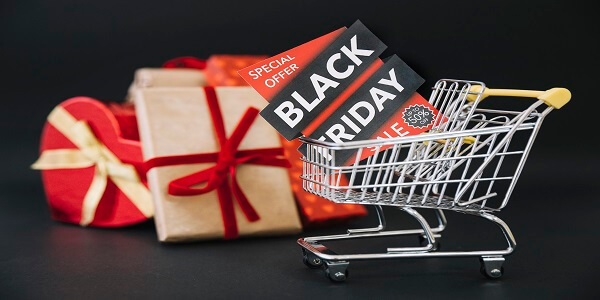 Shopping cart with Black Friday special offer tags and gift boxes, representing how loyalty program software converts Black Friday shoppers into long-term loyal customers.
